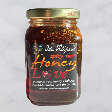 Jar of spicy honey with a label on a light gray background